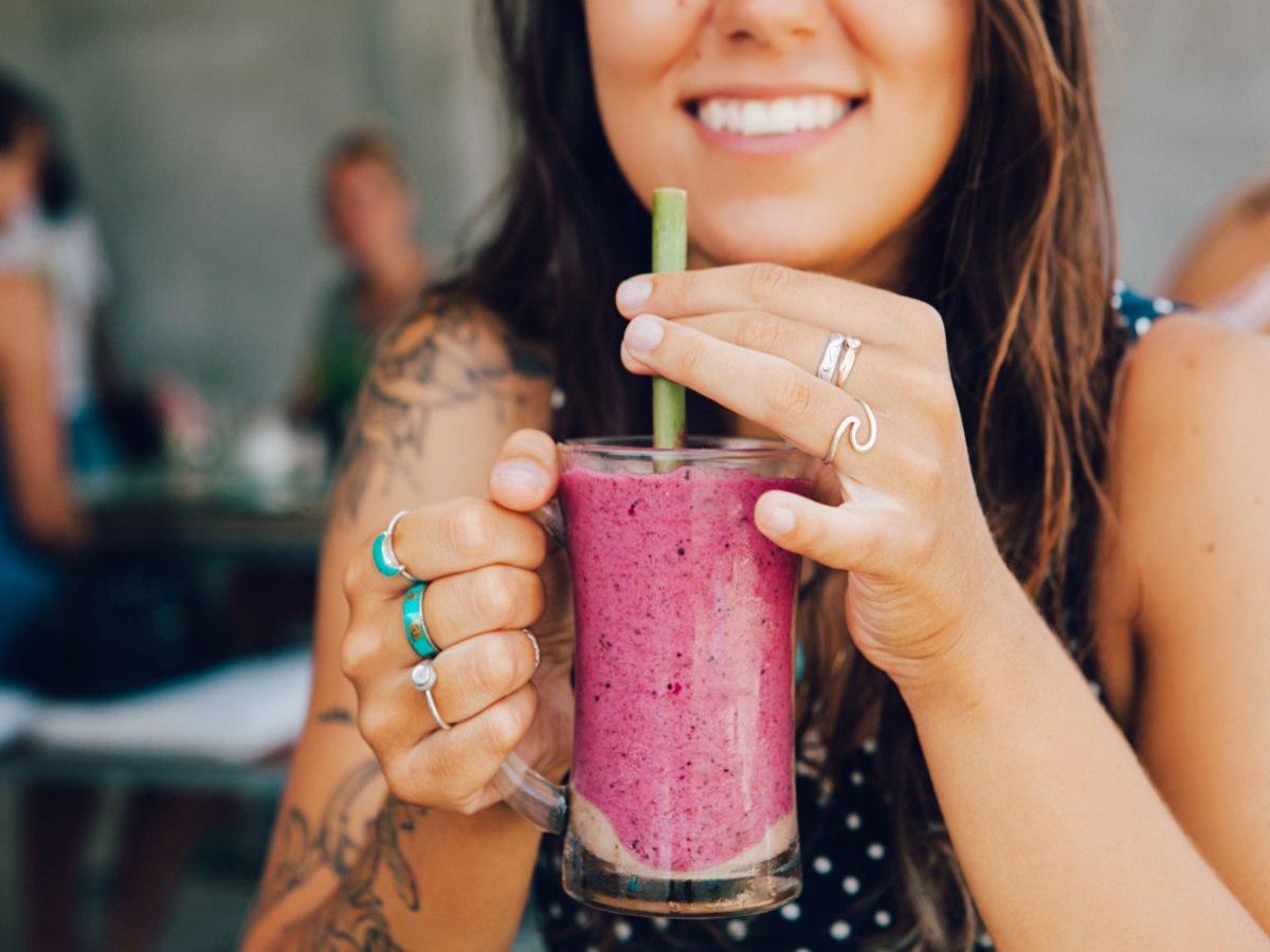 A woman drinking a smoothie