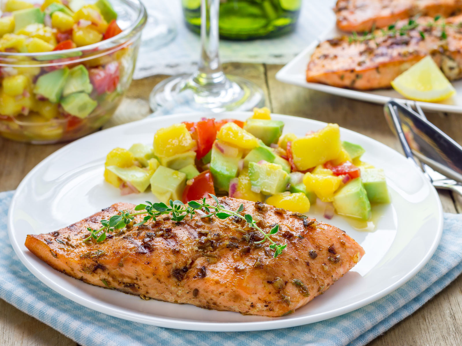 salmon fillet with avocado salsa on a plate