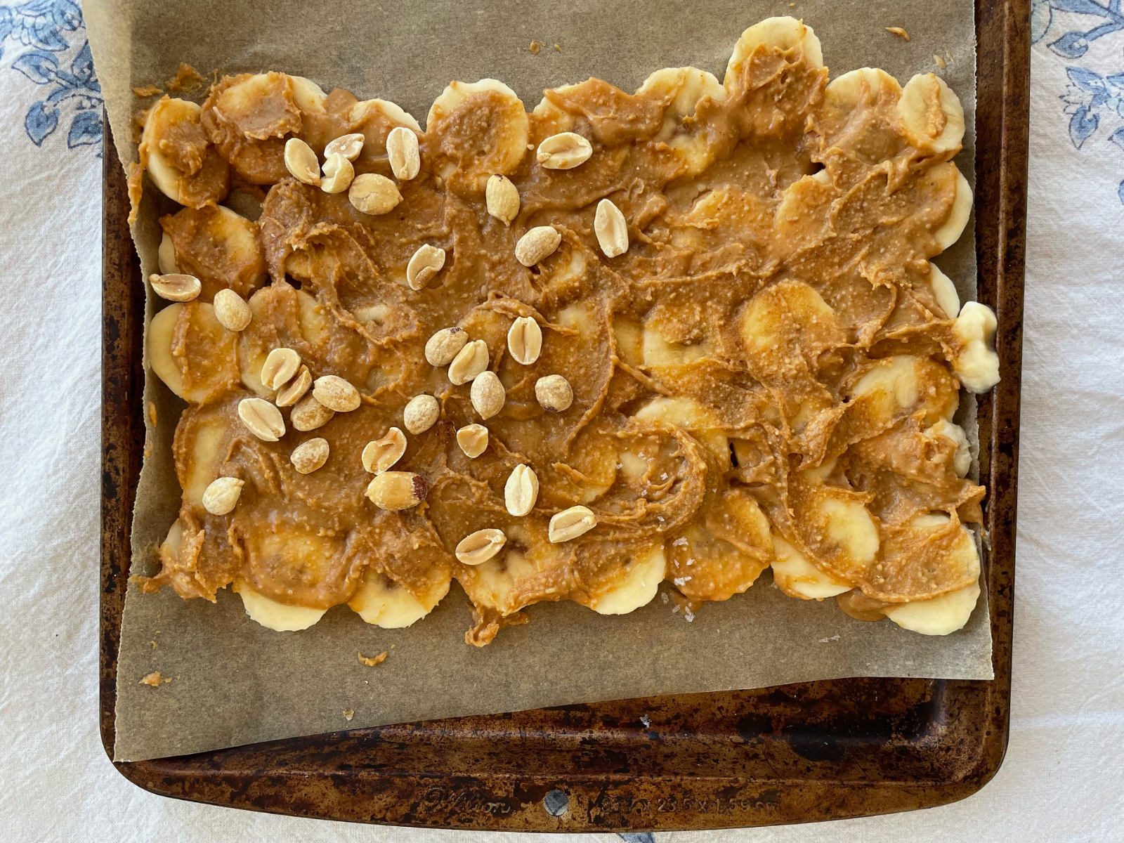 spreading out banana slices and peanut butter for banana bark