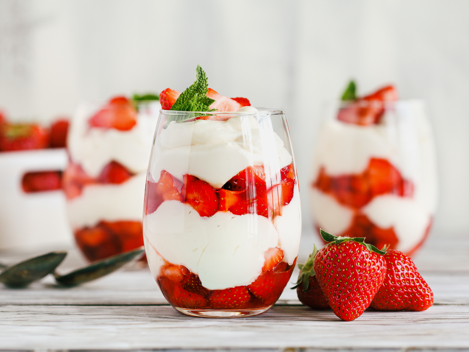 yogurt parfait with strawberries layered in a cup