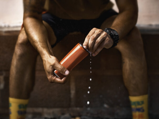 athlete opening an energy drink