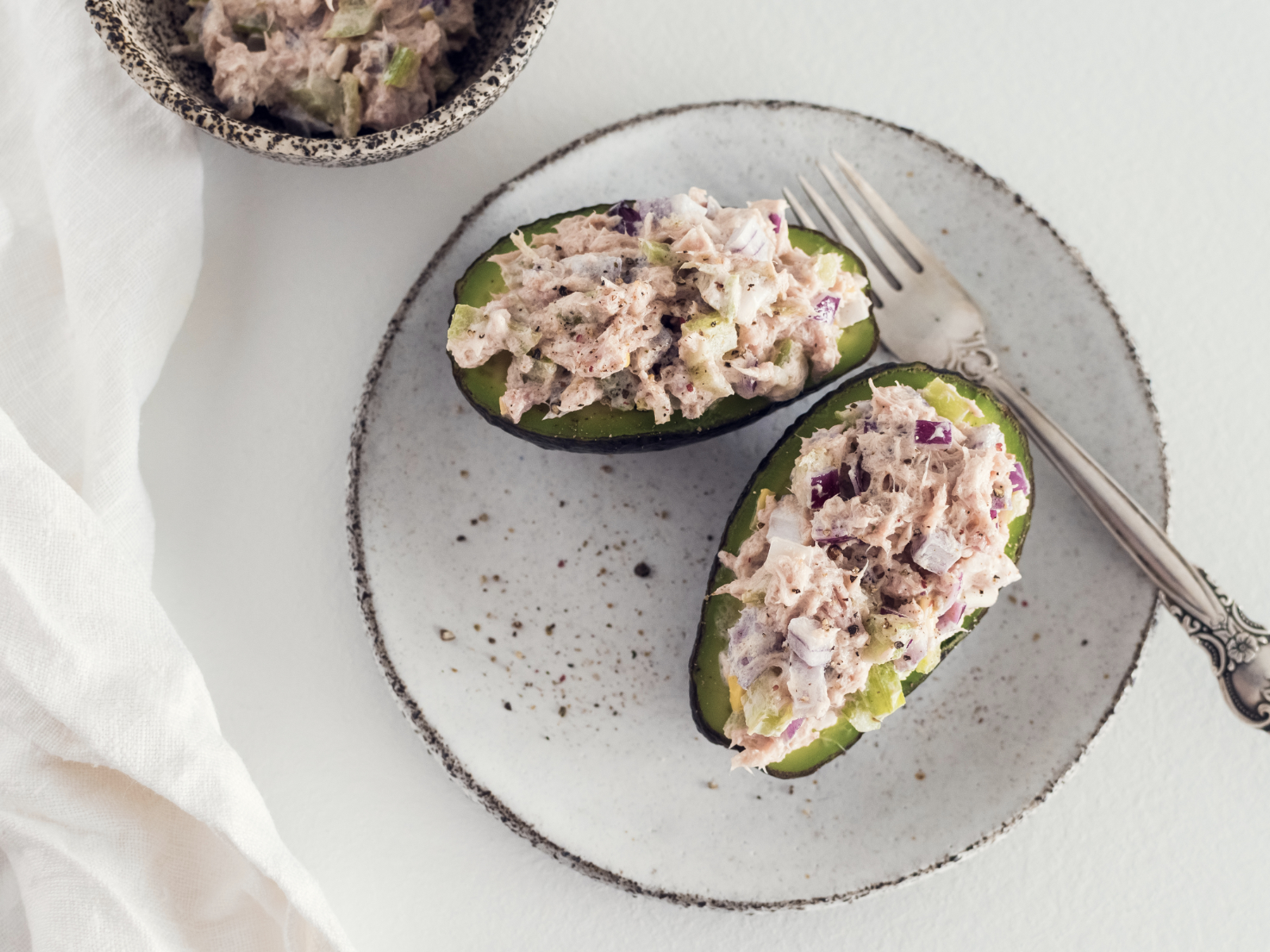 canned fish salad in avocado halves