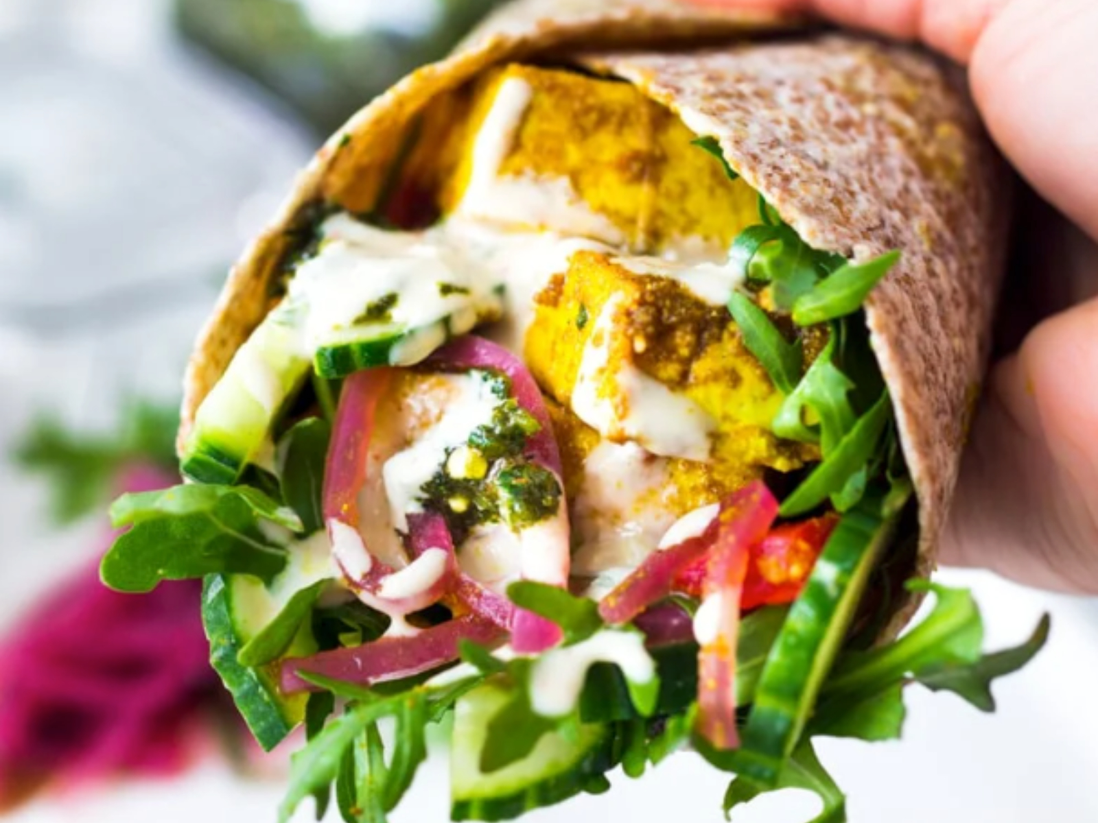 baked chicken shawarma with veggies in a wrap