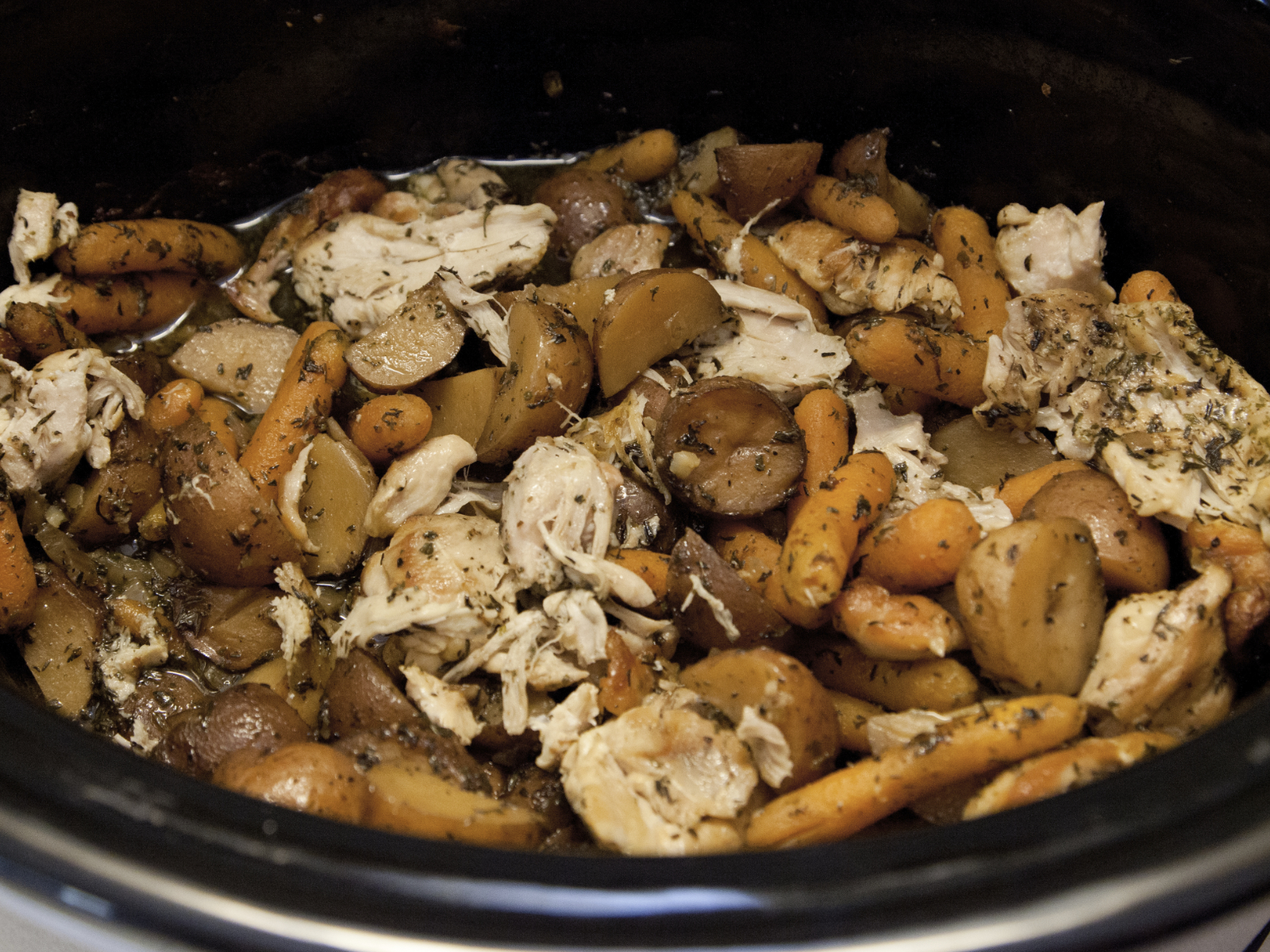 chicken carrots and potatoes with italian seasoning in a crock pot