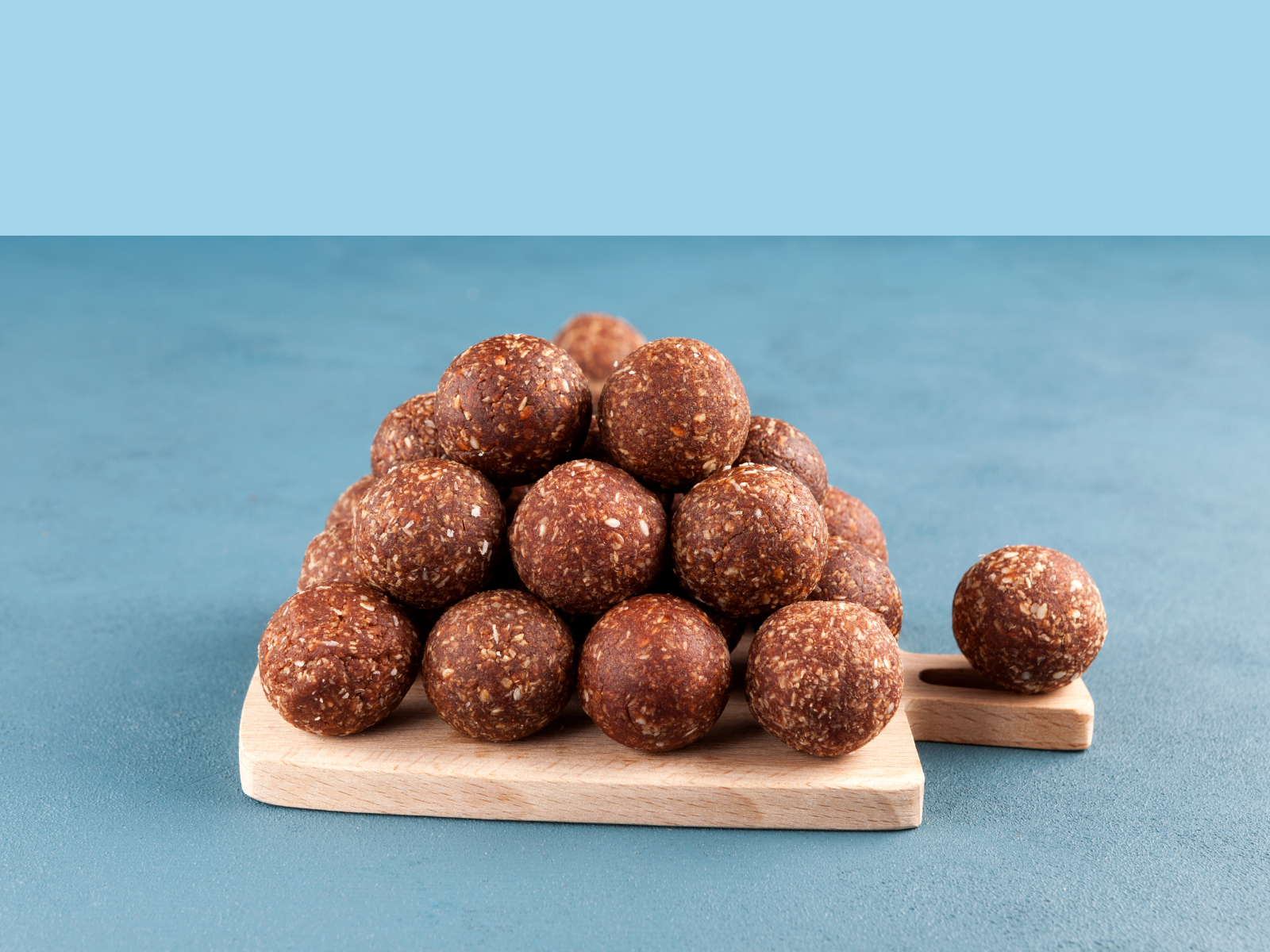 energy balls stacked up o a cutting board
