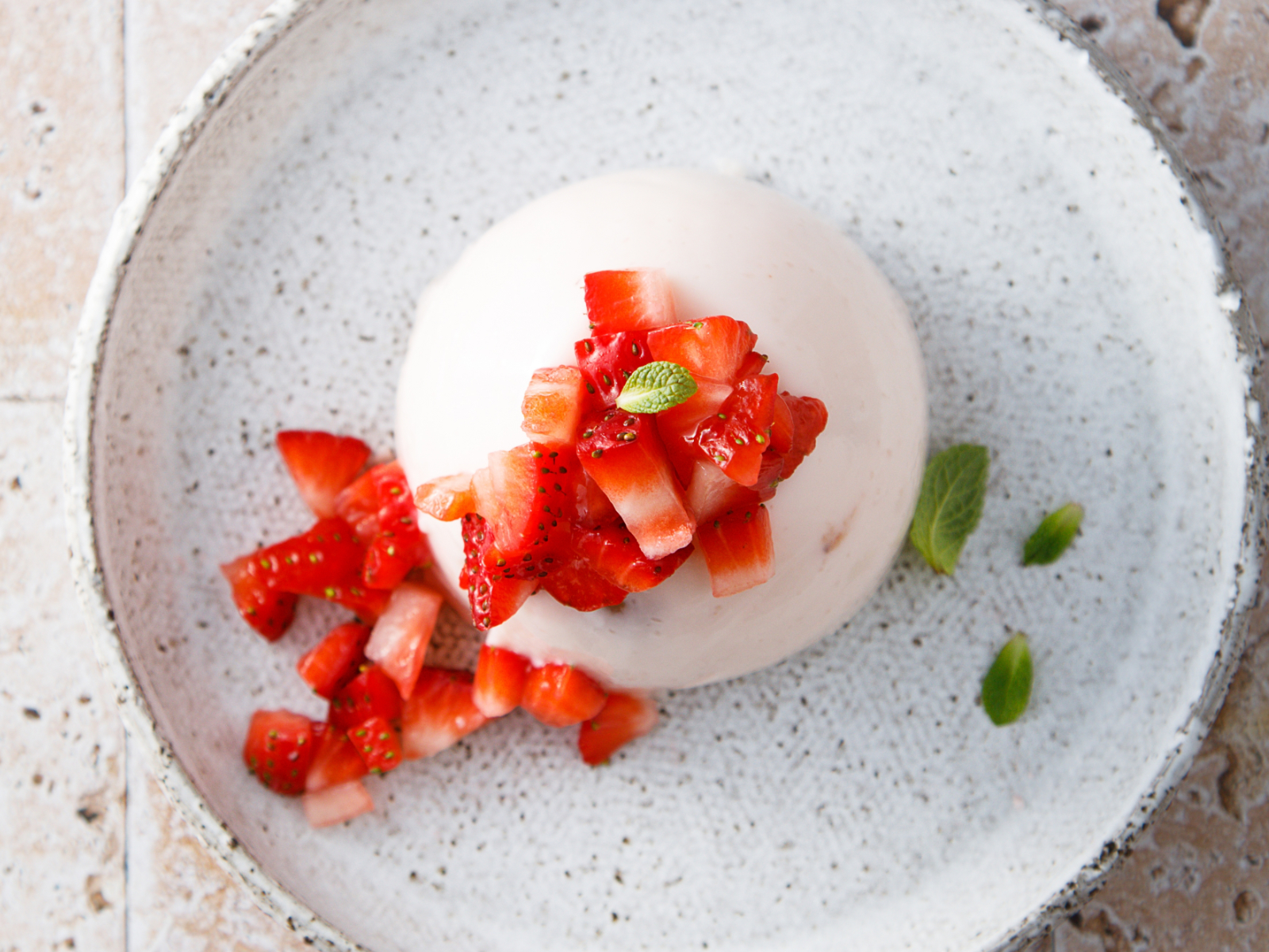 chamomile panna cotta with strawberries piled on top