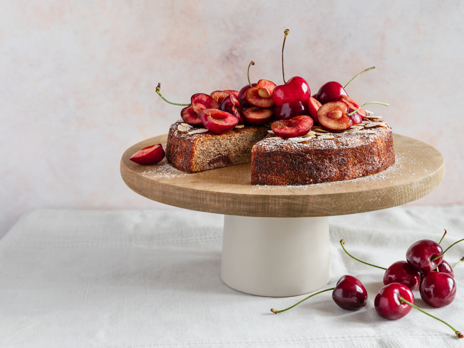 cherry and almond tart on a cake stand