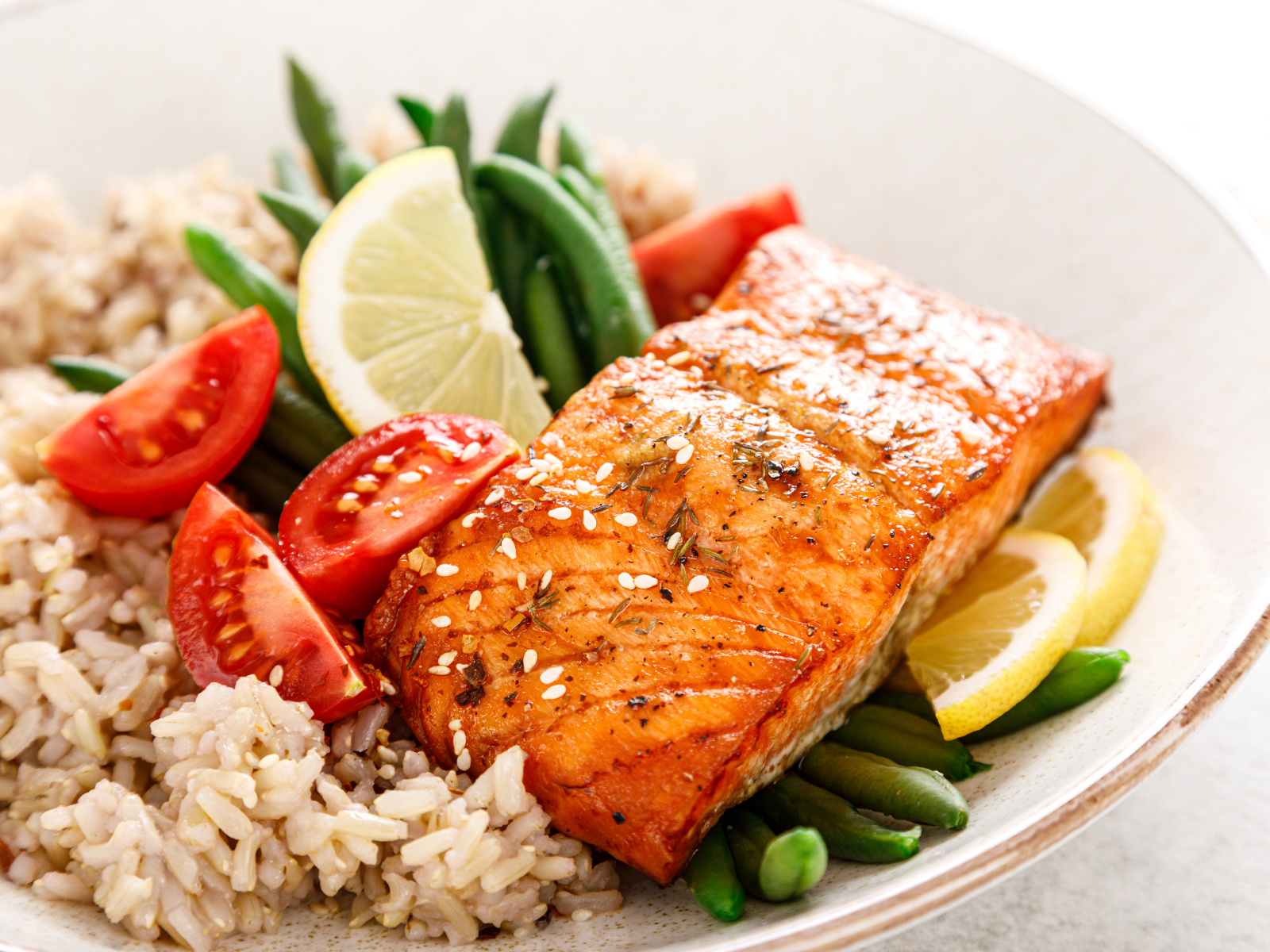 dinner plate of salmon with brown rice and veggies