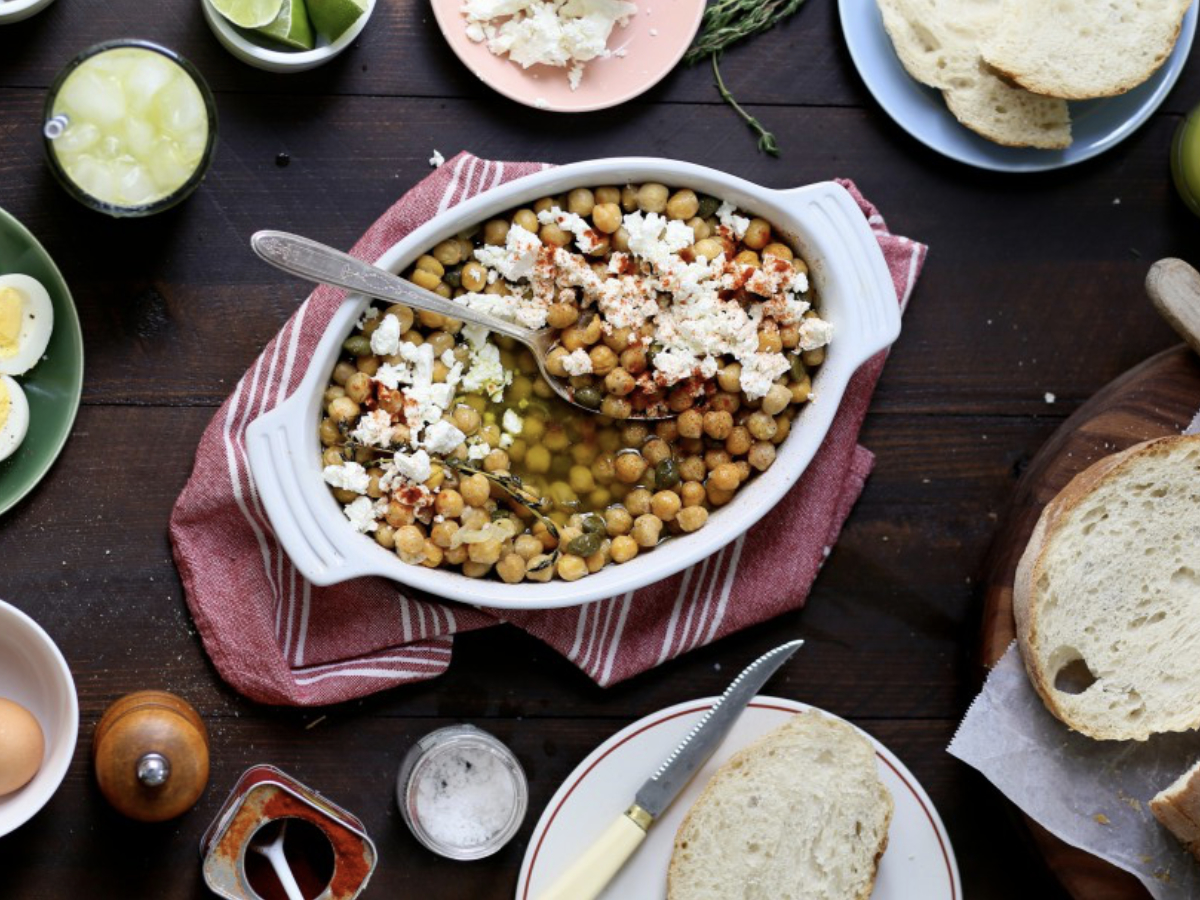 chickpeas with feta on a dinner table with bread