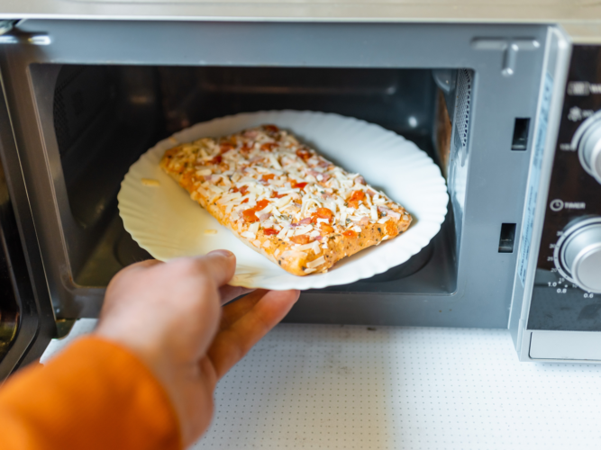 putting a frozen pizza in a microwave