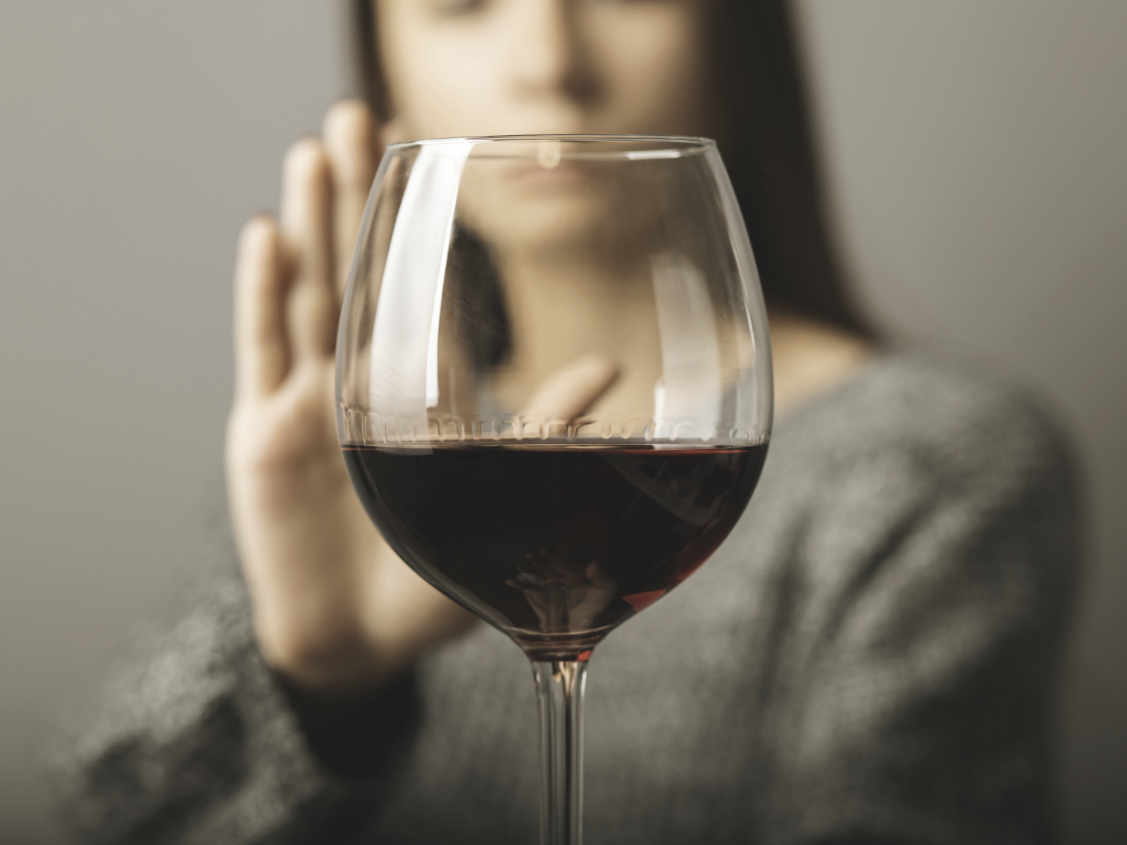 woman refusing glass of red wine