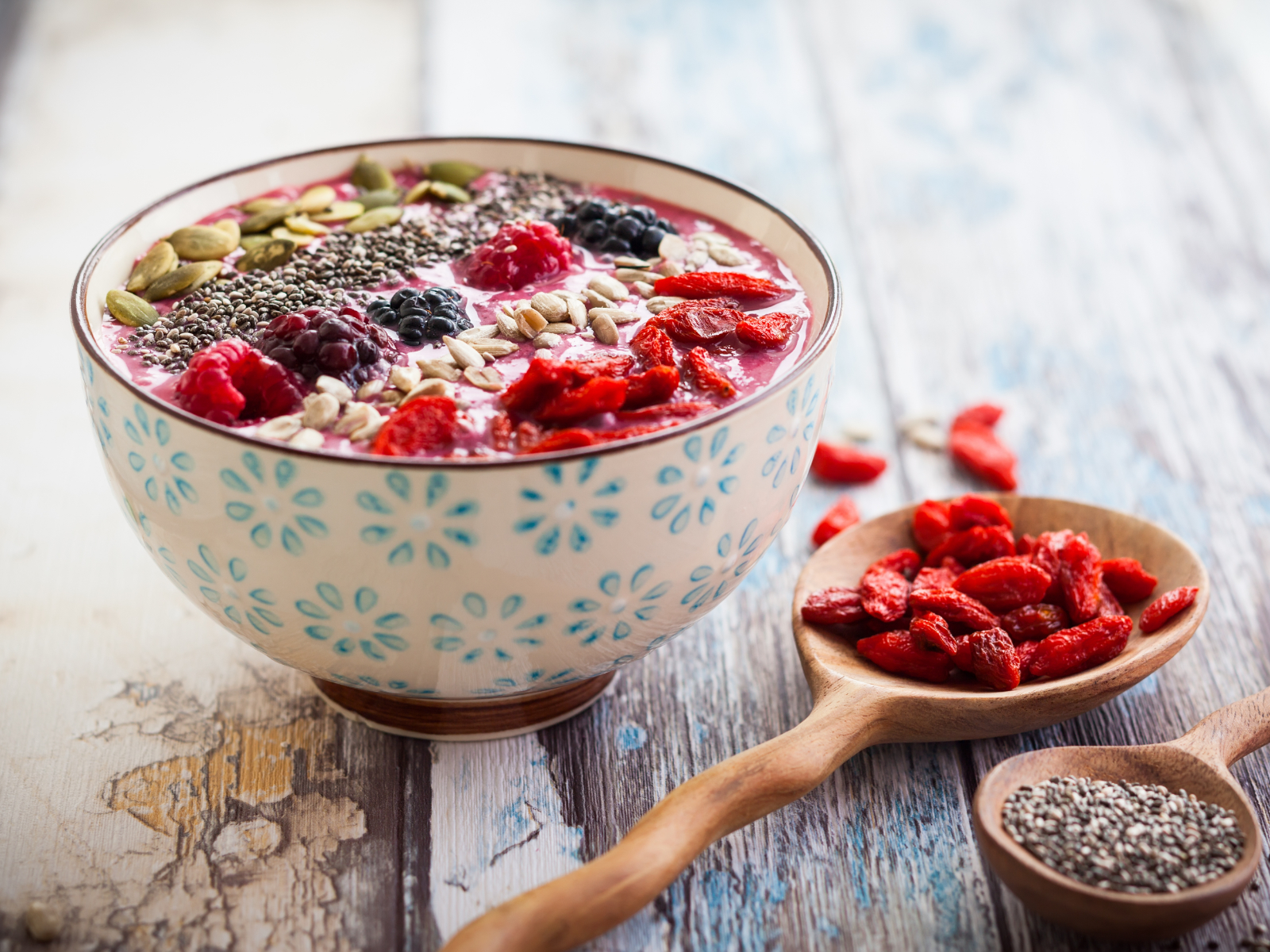 smoothie bowl topped with berries seeds coconut and goji berries