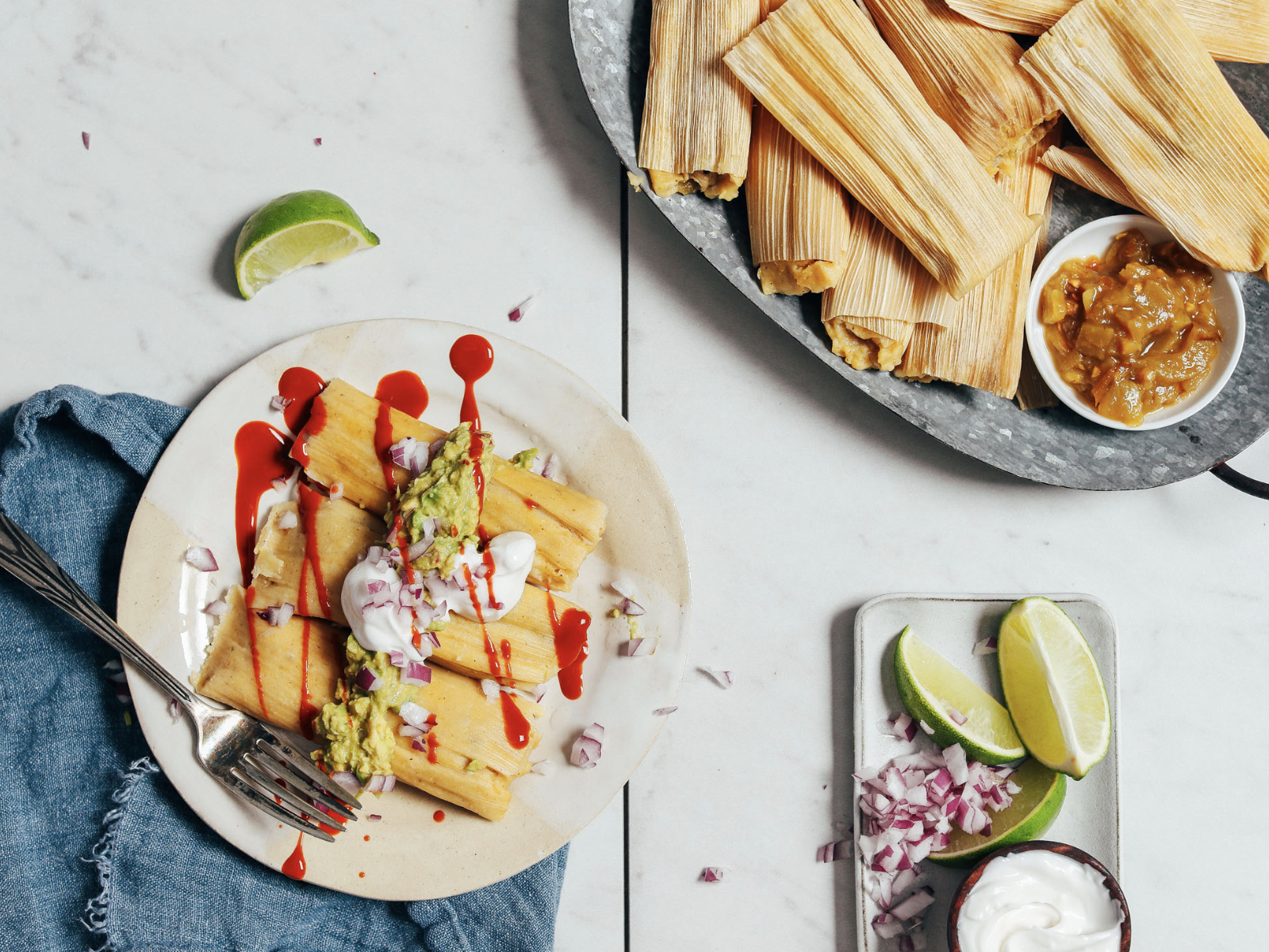 green chile tamales with sauce and limes