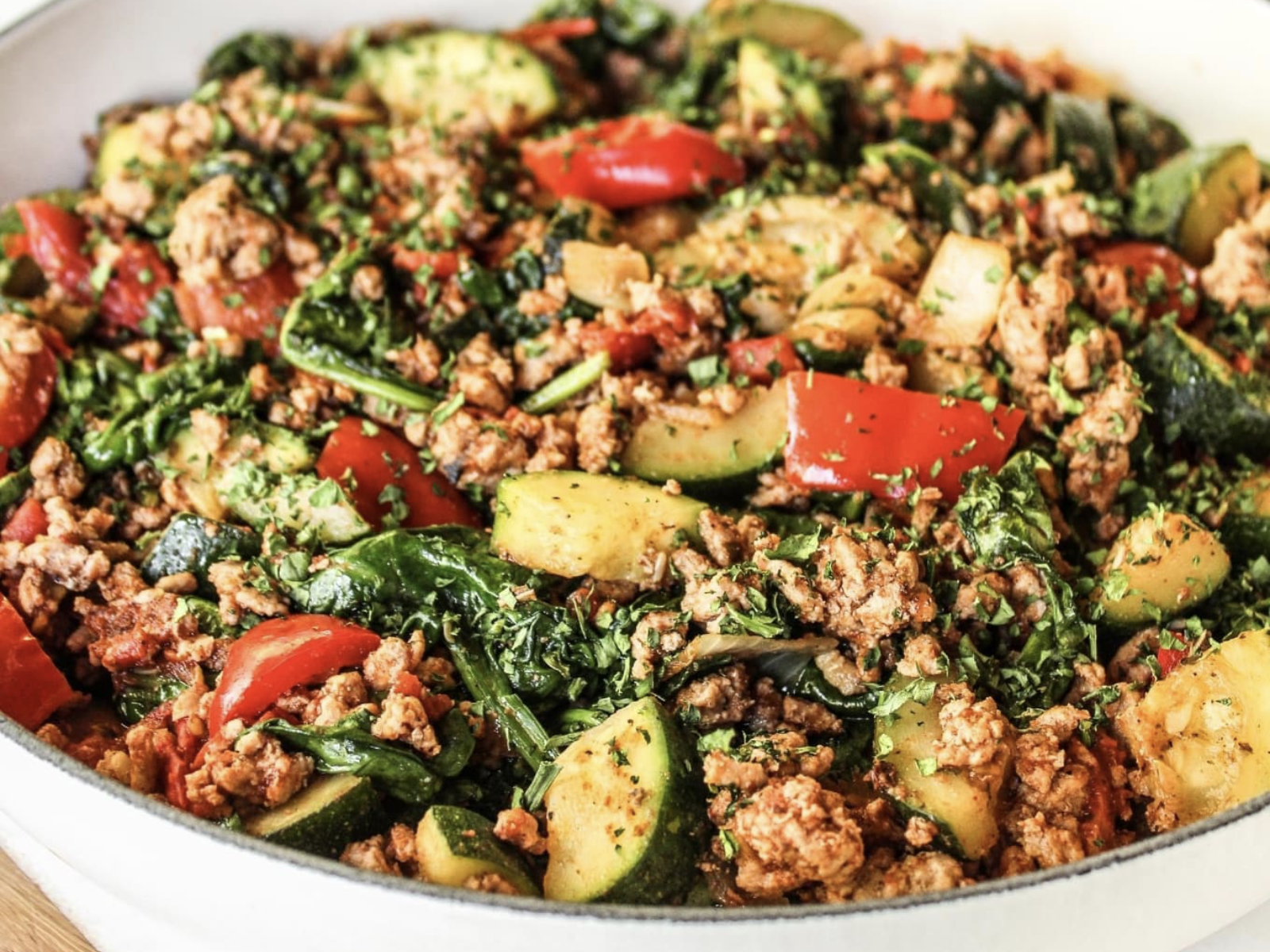 skillet with zucchini and veggies and cooked ground turkey
