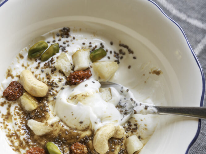 bowl of yogurt with chia seeds and nuts