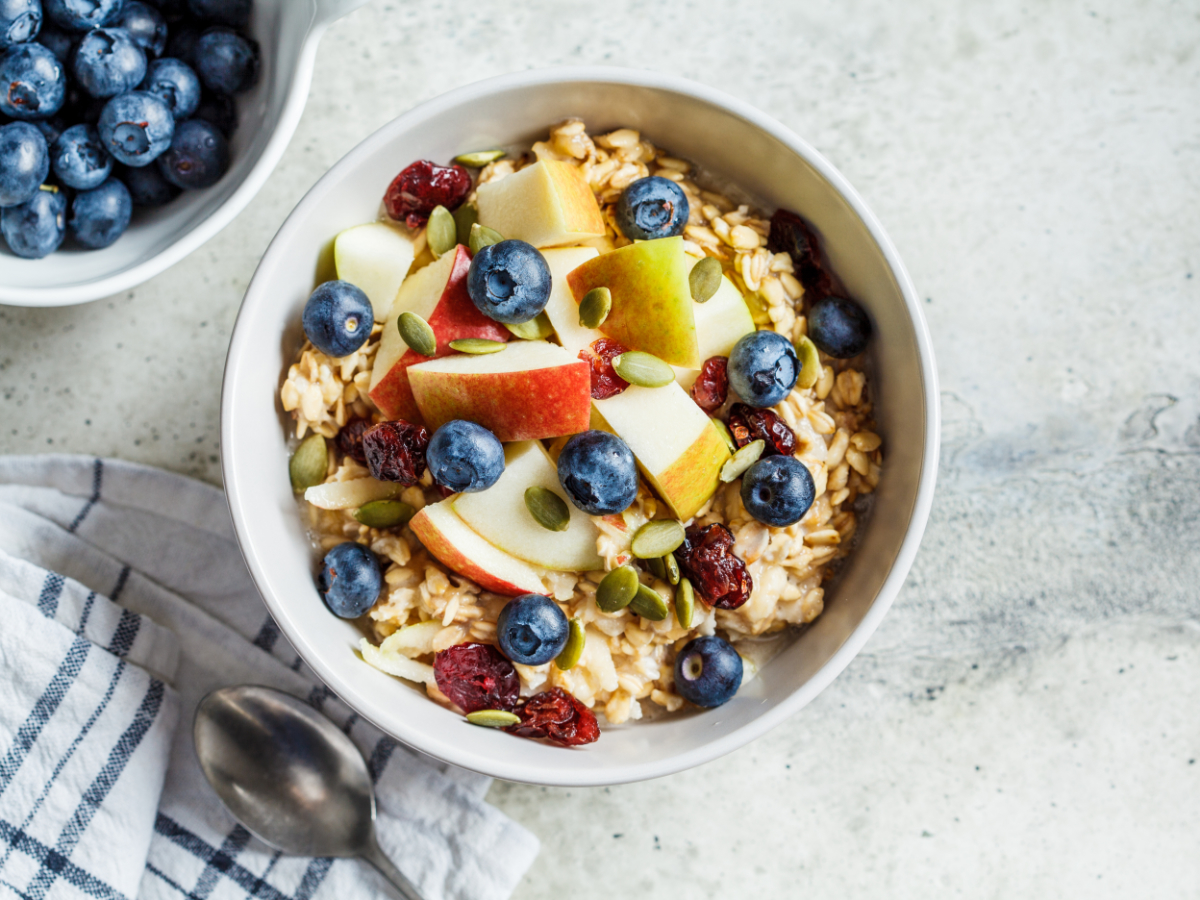 healthy bowl of oatmeal with berries and apples