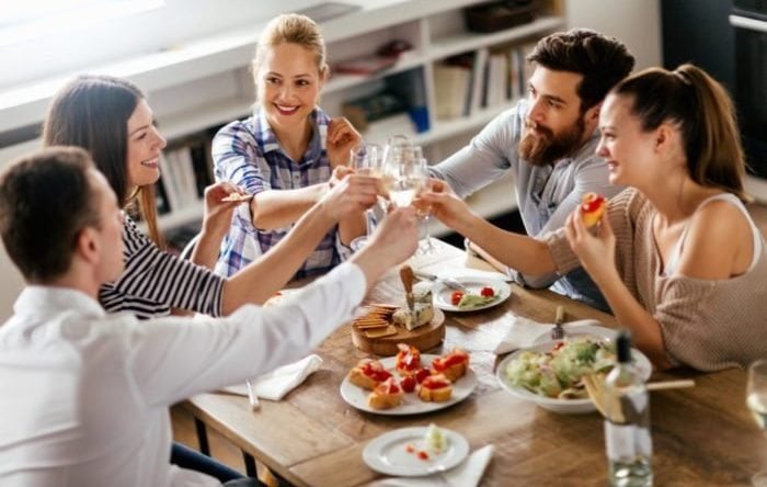 Group of friends enjoying eating and drinking together