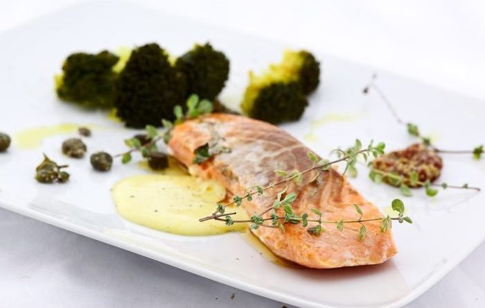 Salmon cooked sous vide with a mustard mayonnaise and steamed broccoli