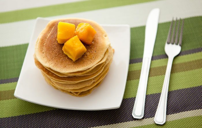 High-protein pancakes made from chickpea/garbanzo bean/gram flour topped with mangoes.