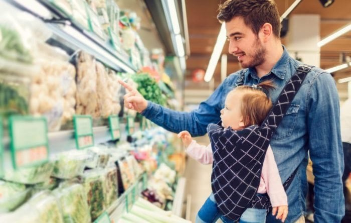 Father and his baby girl groceries shopping in local supermarket