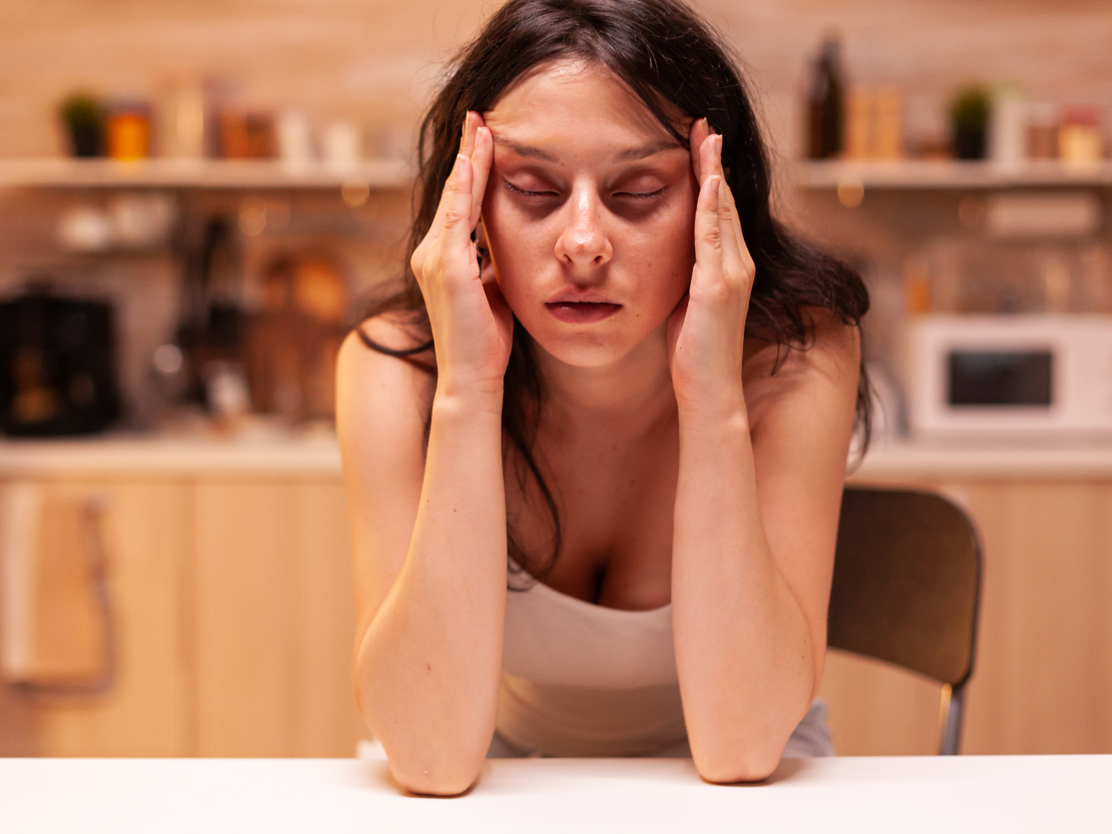 woman looking mentally drained at the table