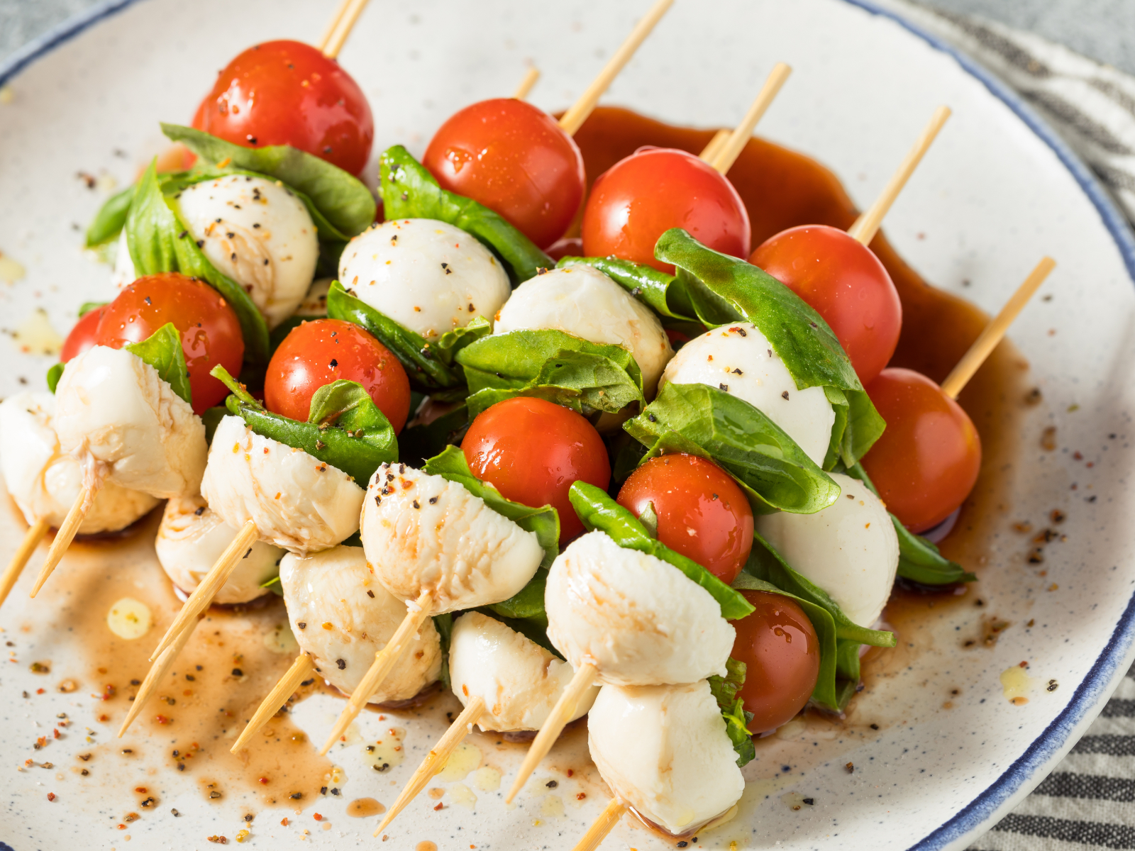 caprese skewers with balsamic glaze on a plate