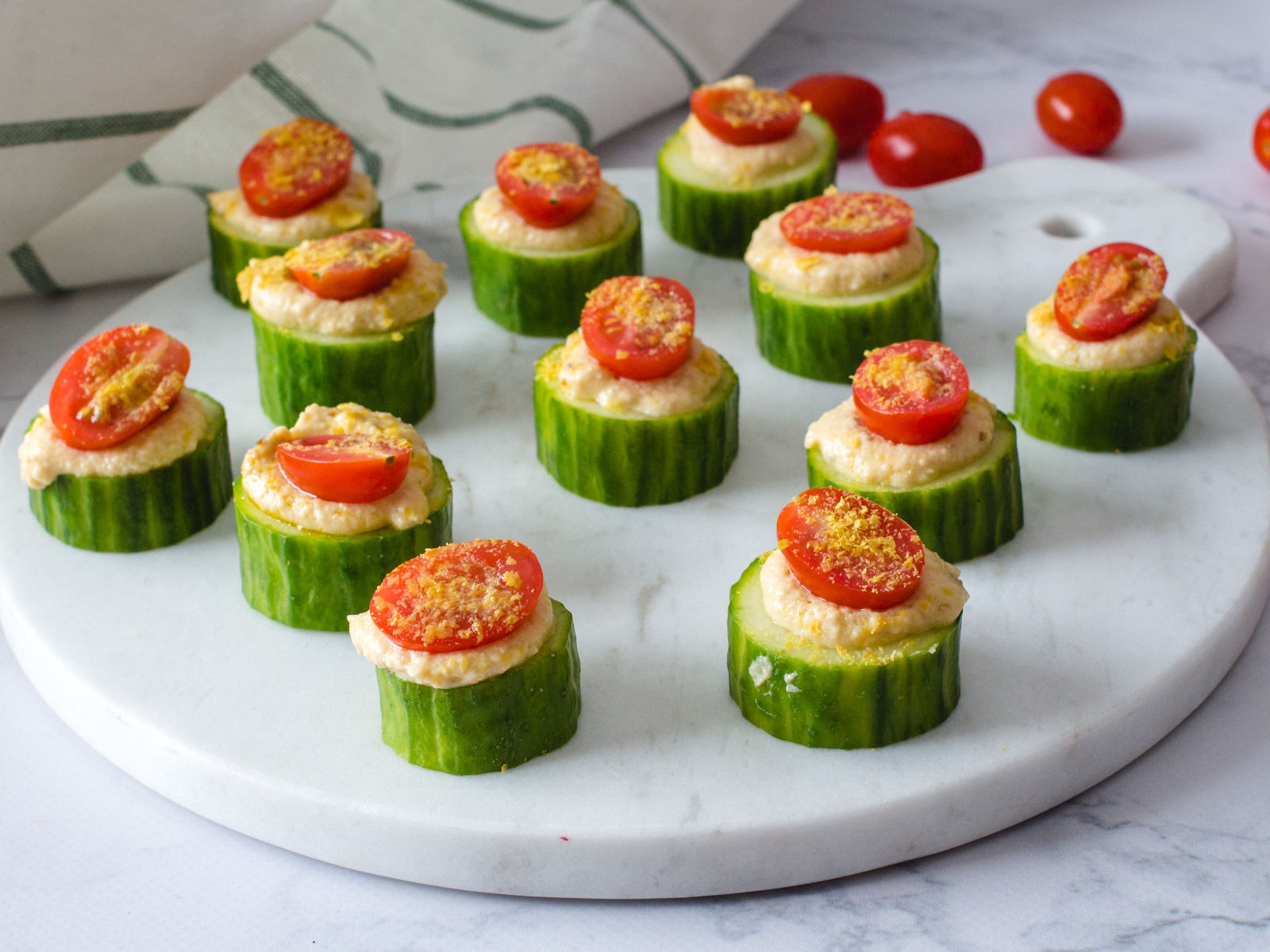 cucumber bites with dip or salad and sliced tomatoes