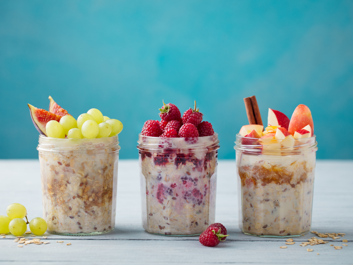 overnight oats in jars with raspberries grapes and apples