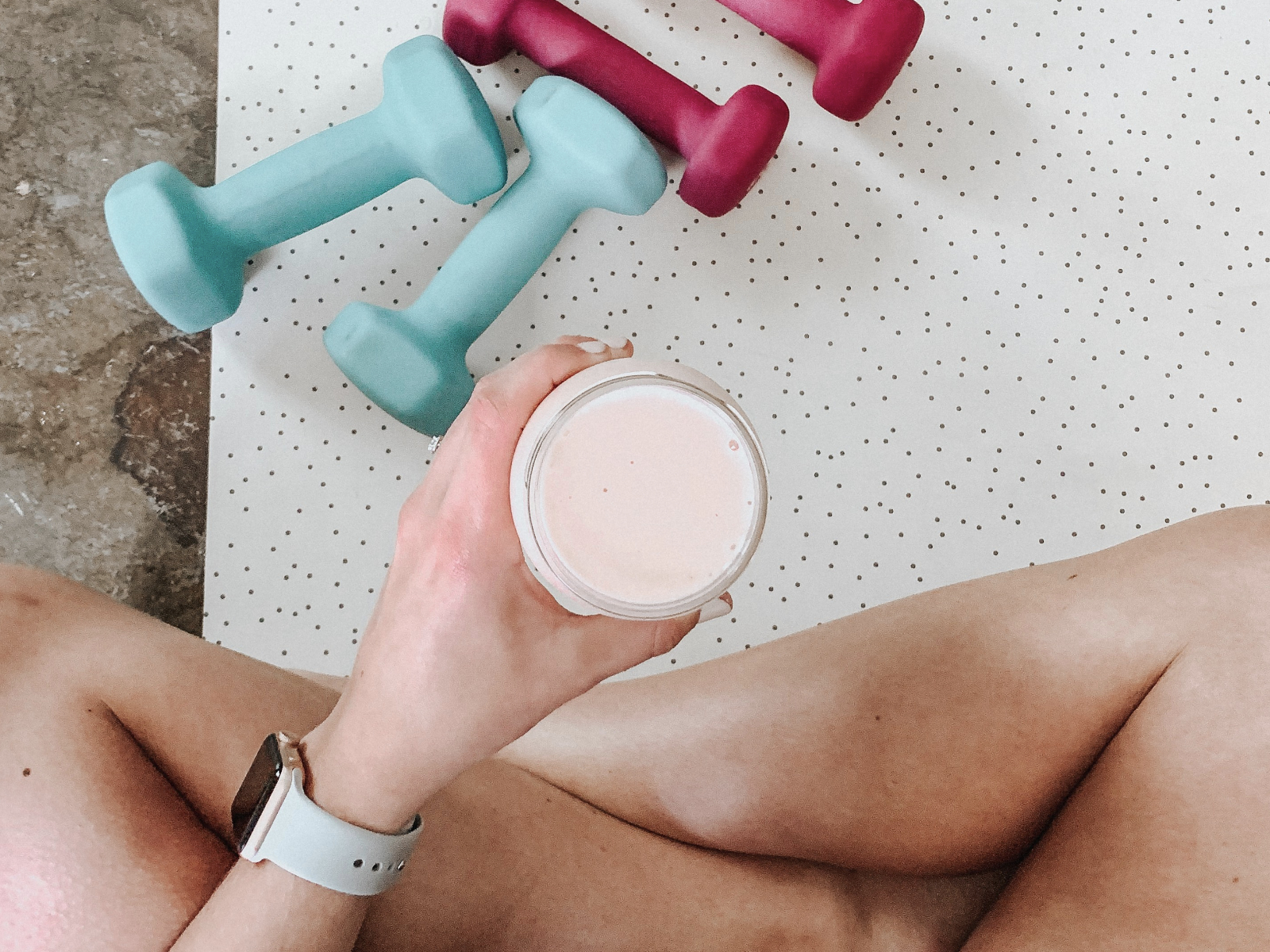 woman holding protein shake after a workout