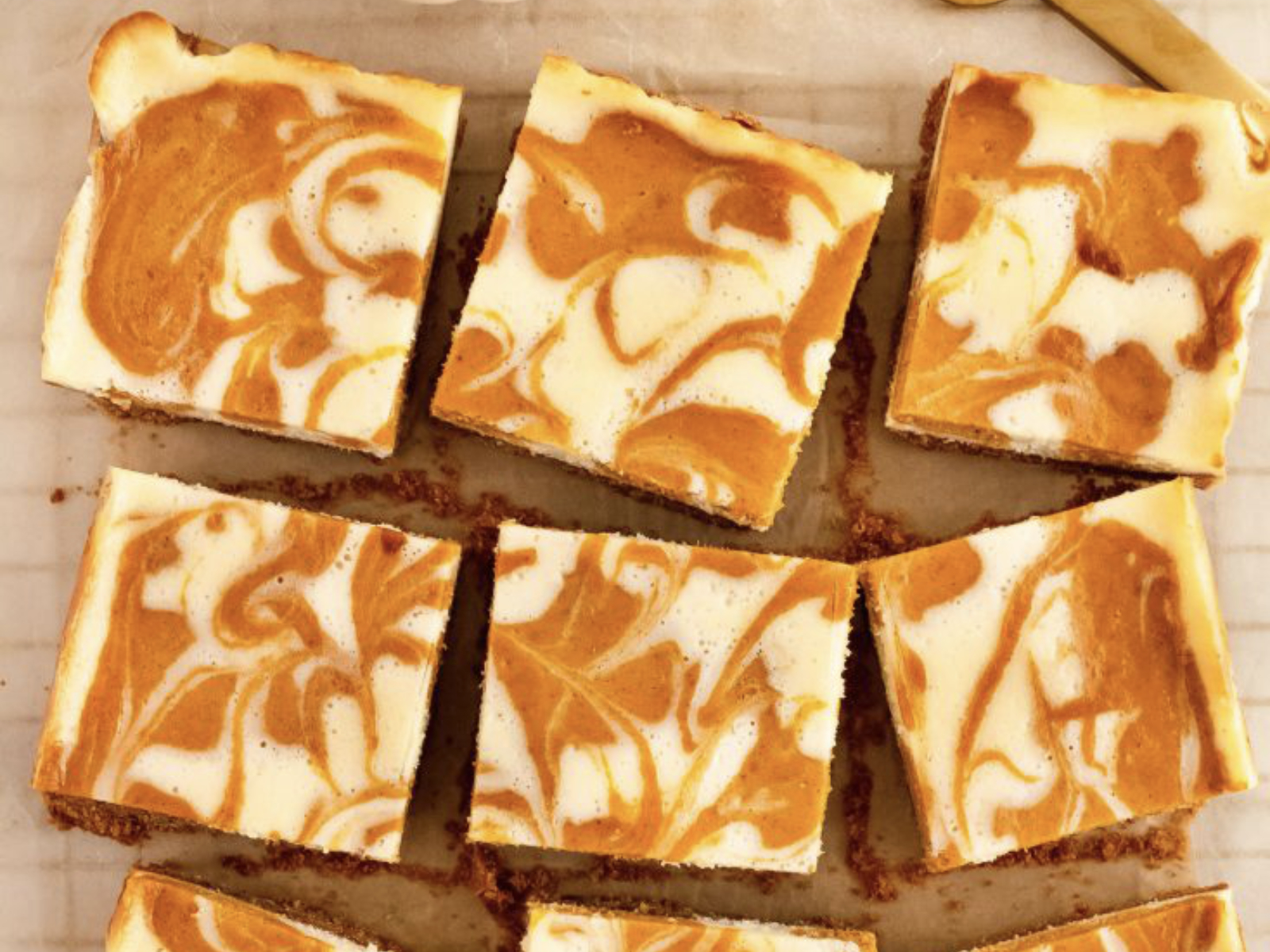 pumpkin cheesecake bars sliced and ready to serve