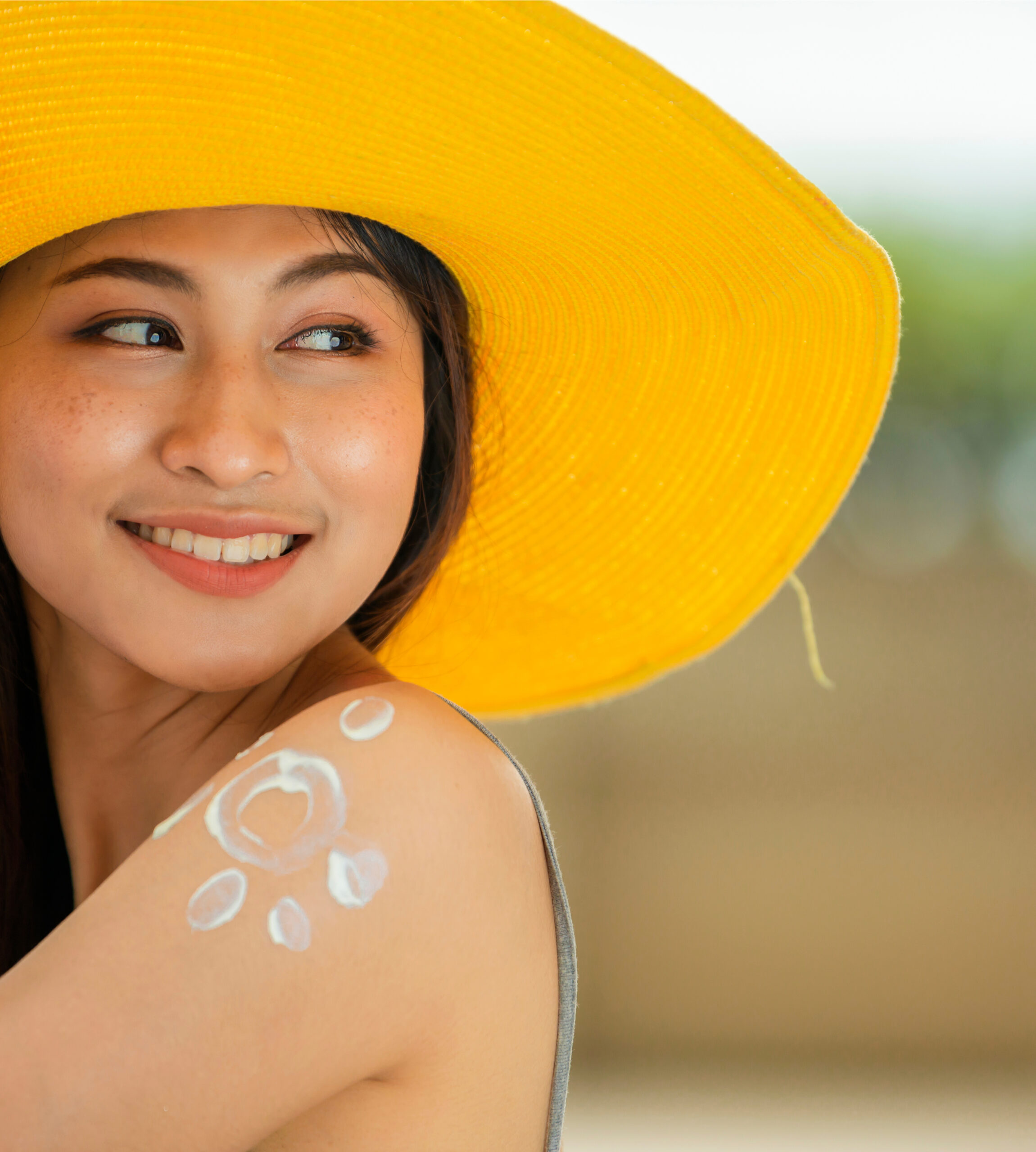 a young woman with sunscreen on her arm