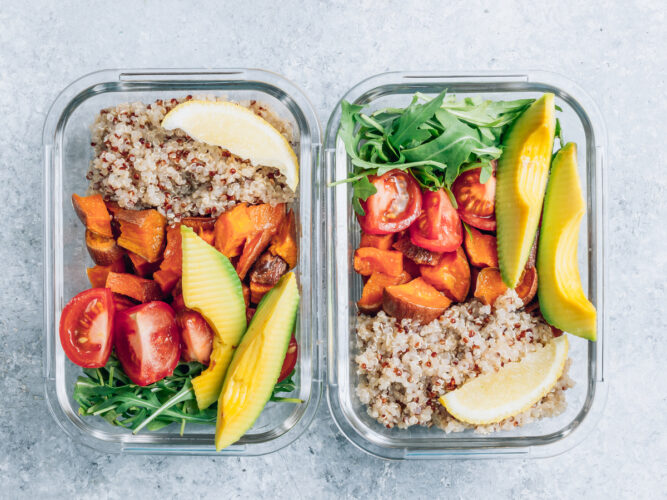 meal prep containers filled with quinoa, avocado, lemon, etc
