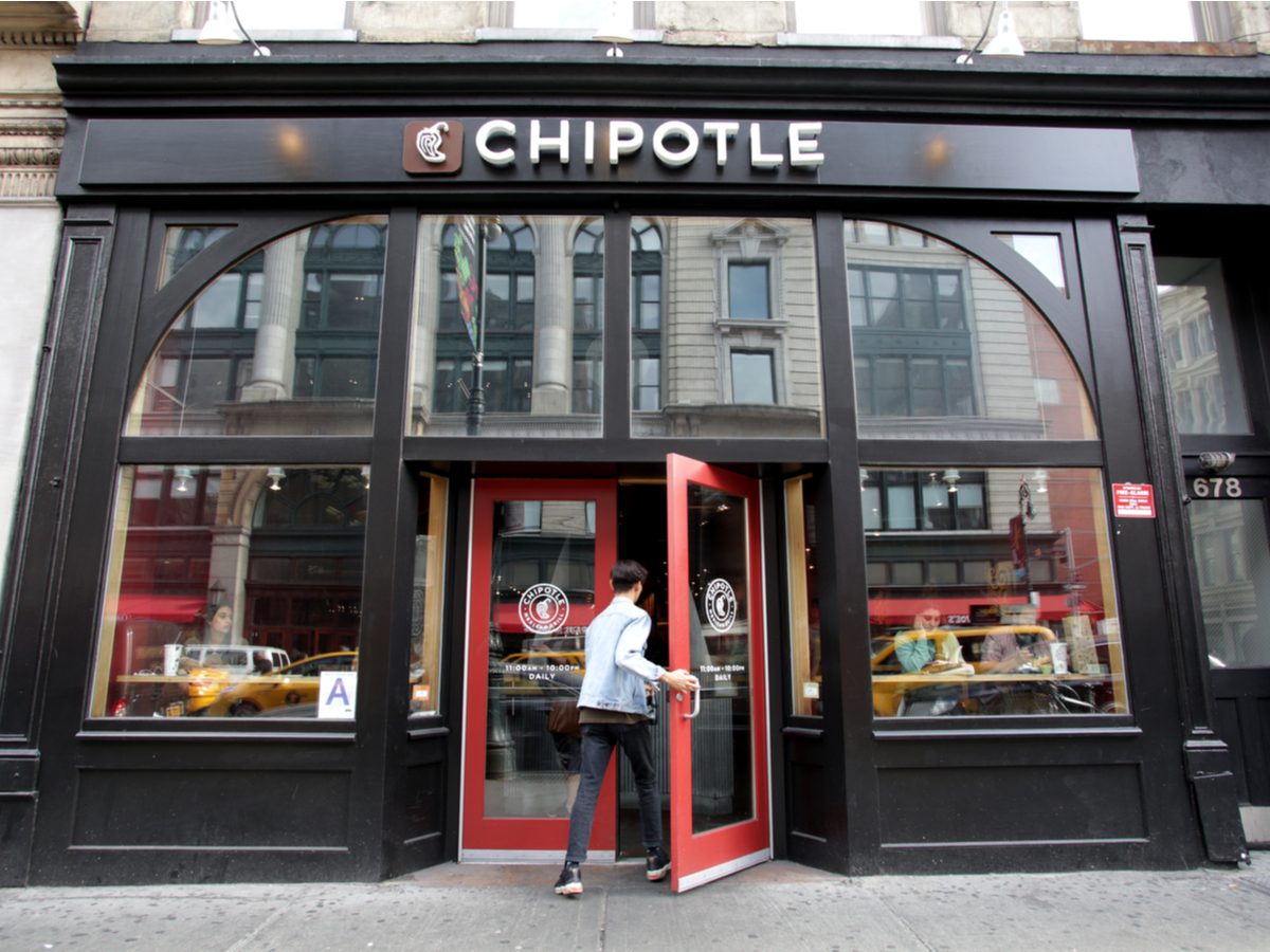Is Chipotle healthy? Image of a man walking into a Chipotle in an urban setting