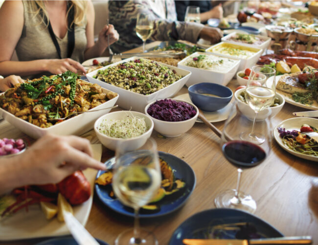 people enjoying a dinner party with fresh whole foods