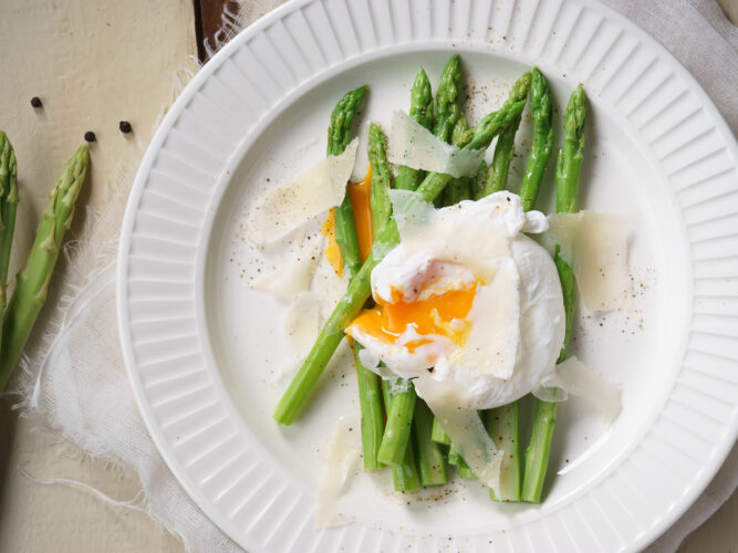 poached egg on top of steamed asparagus