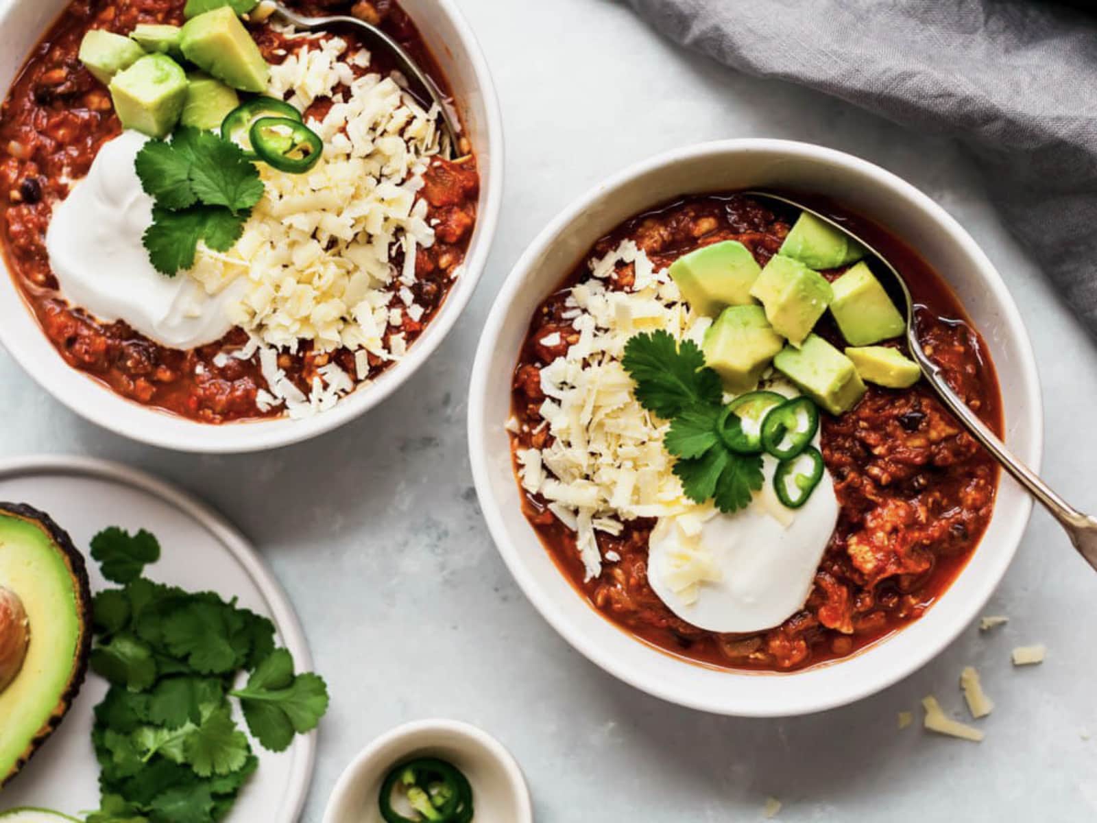 slow cooker black bean pumpkin chili with toppings in bowls