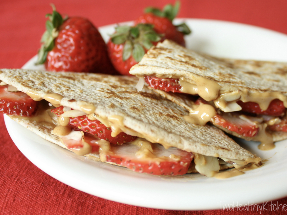 Strawberry peanut butter quesadillas on a red table