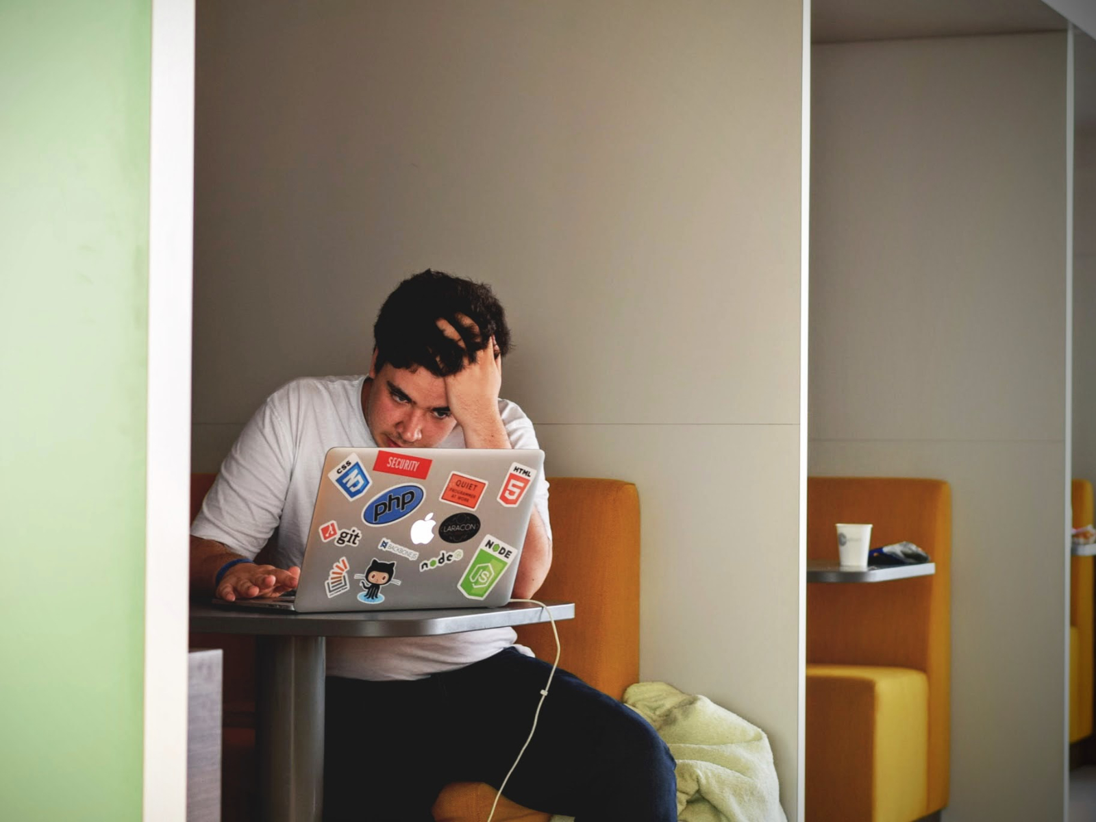 stressed man looking at laptop at work