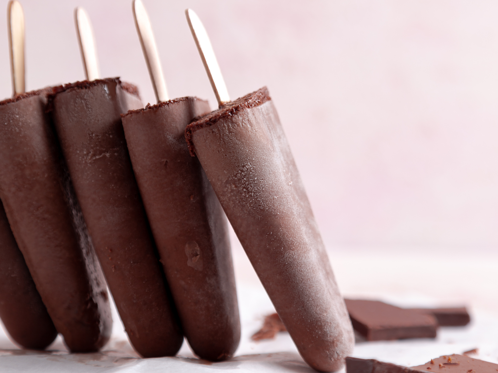 chocolate fudge pops stacked together on a table