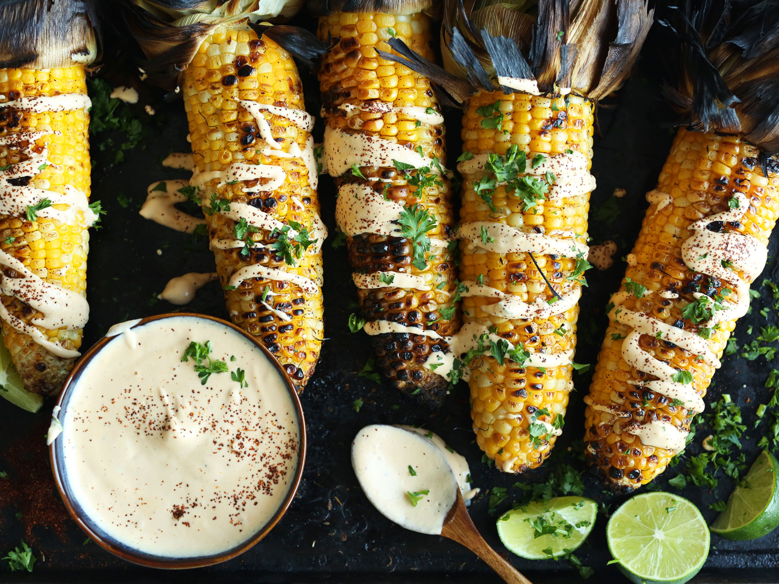 Grilled corn with sriracha aioli drizzled on top