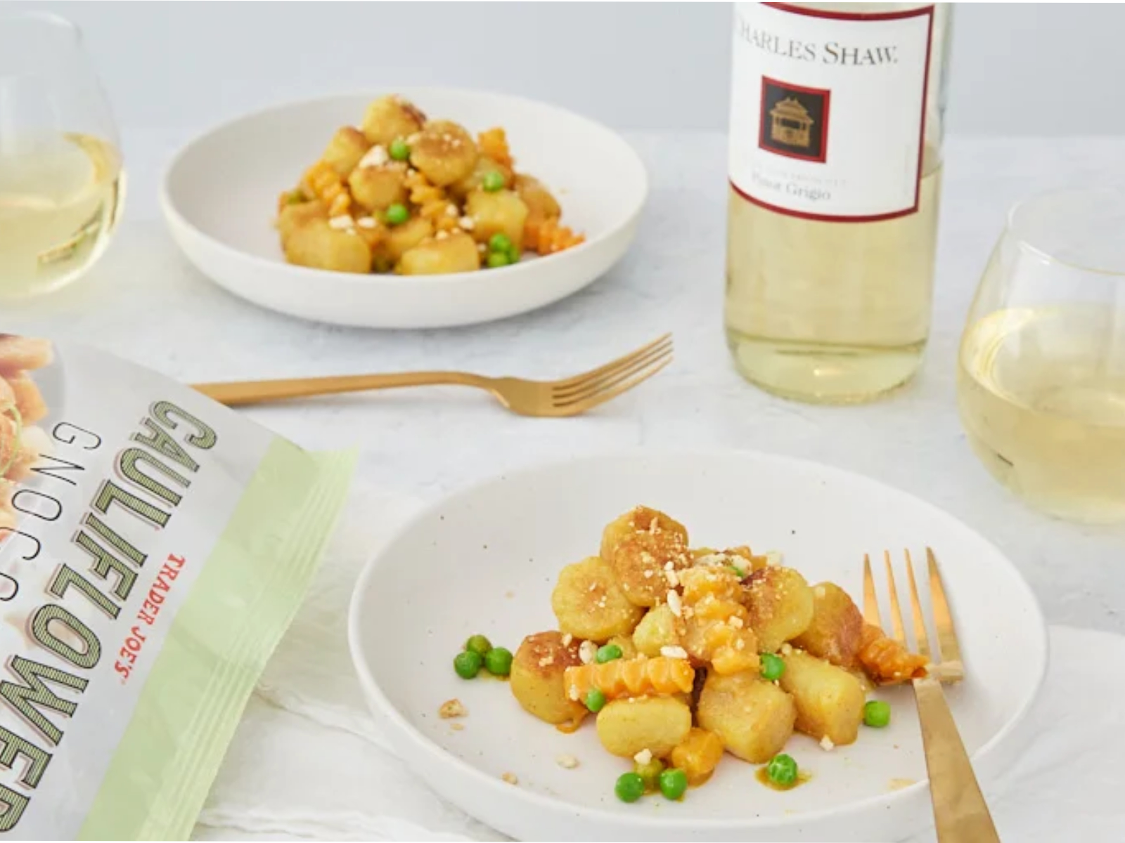 Cauliflower Gnocchi on a plate with veggies and white wine