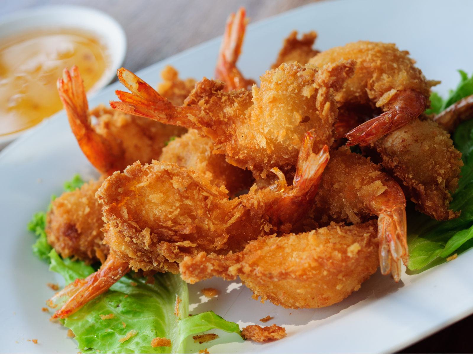 Coconut Shrimp on a plate with dipping sauce