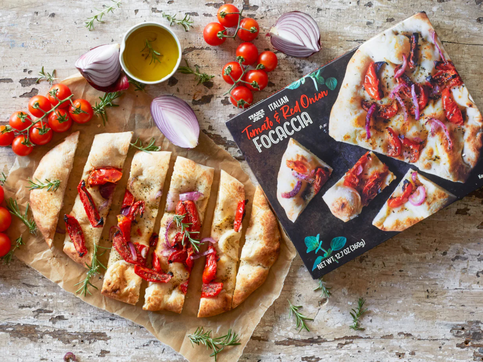 Italian Tomato and Red Onion Focaccia on a counter with tomatoes shallots and oil