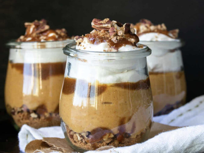 layered pumpkin dessert in jars with crunchy nuts on top