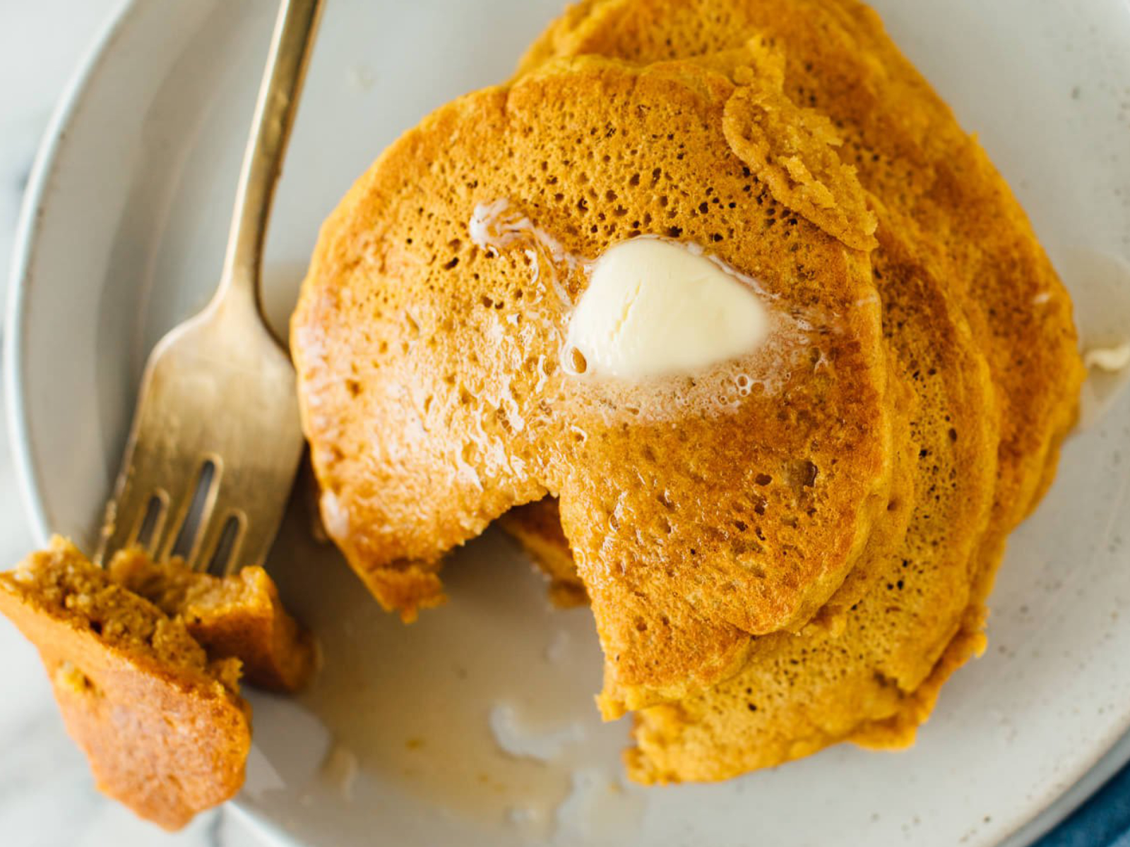 forkful of whole wheat pumpkin pancakes with butter