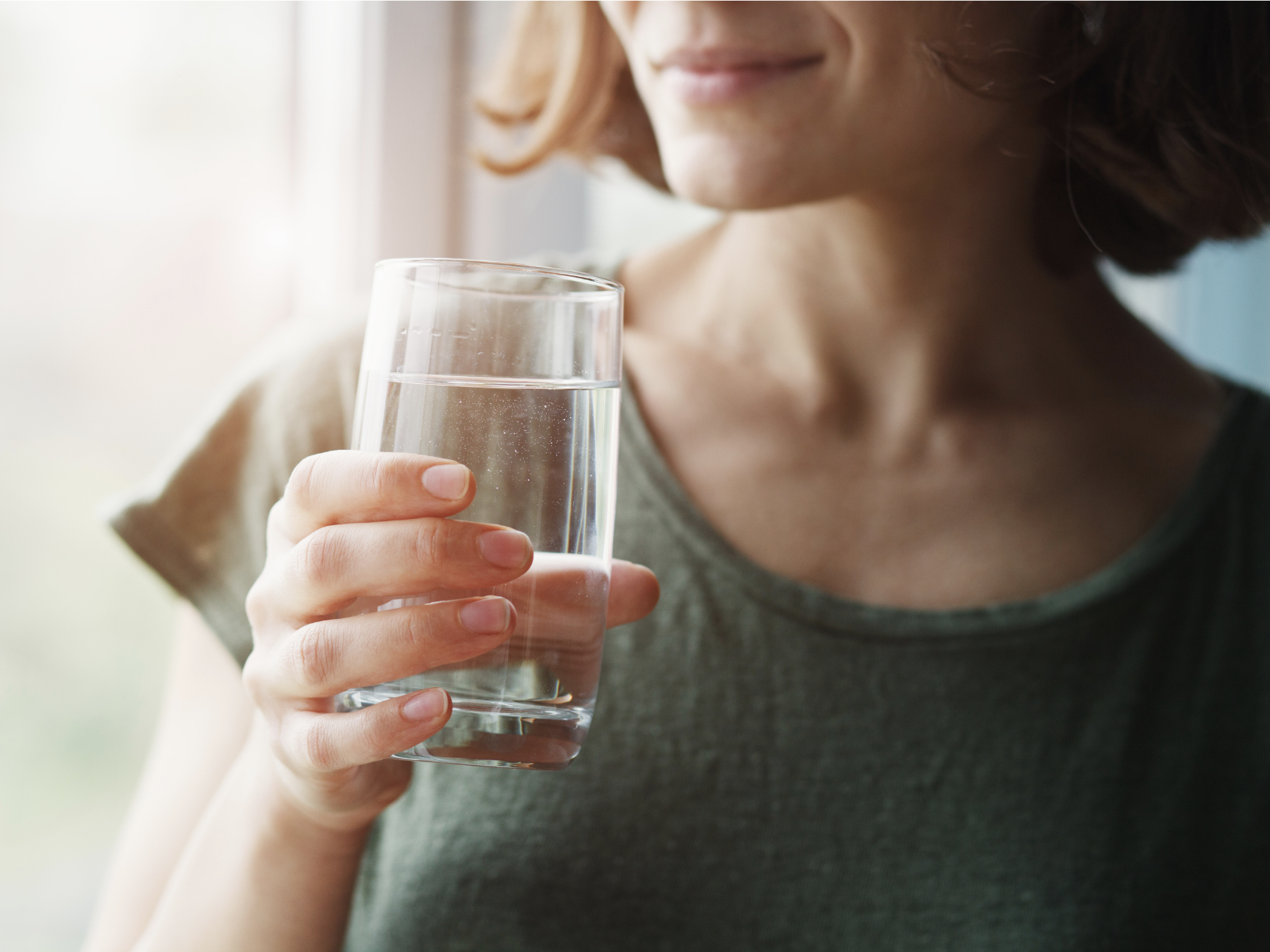 woman drinking water glass